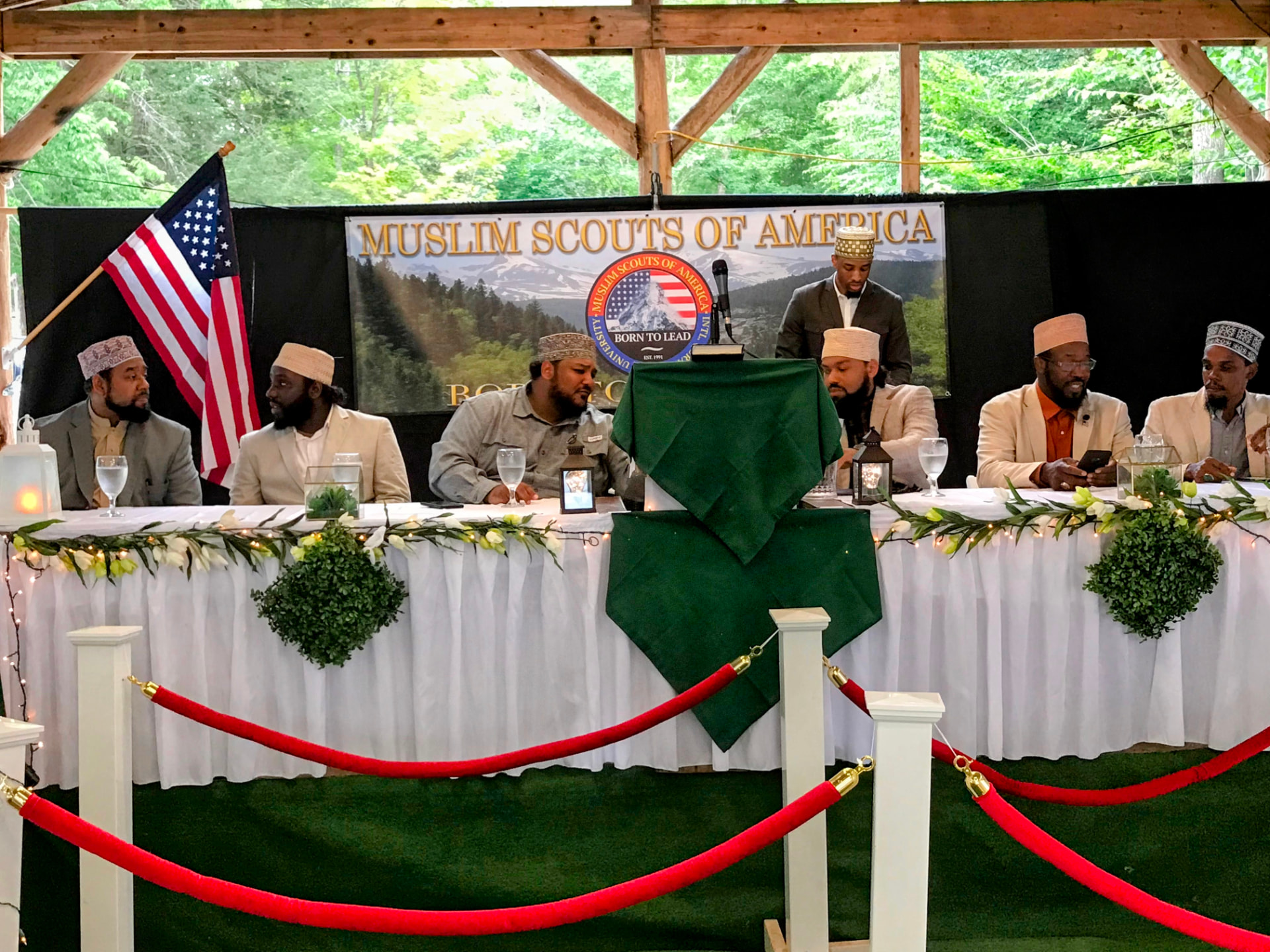 Muslim Scouts of America leadership seated at the head table beneath the MSA banner